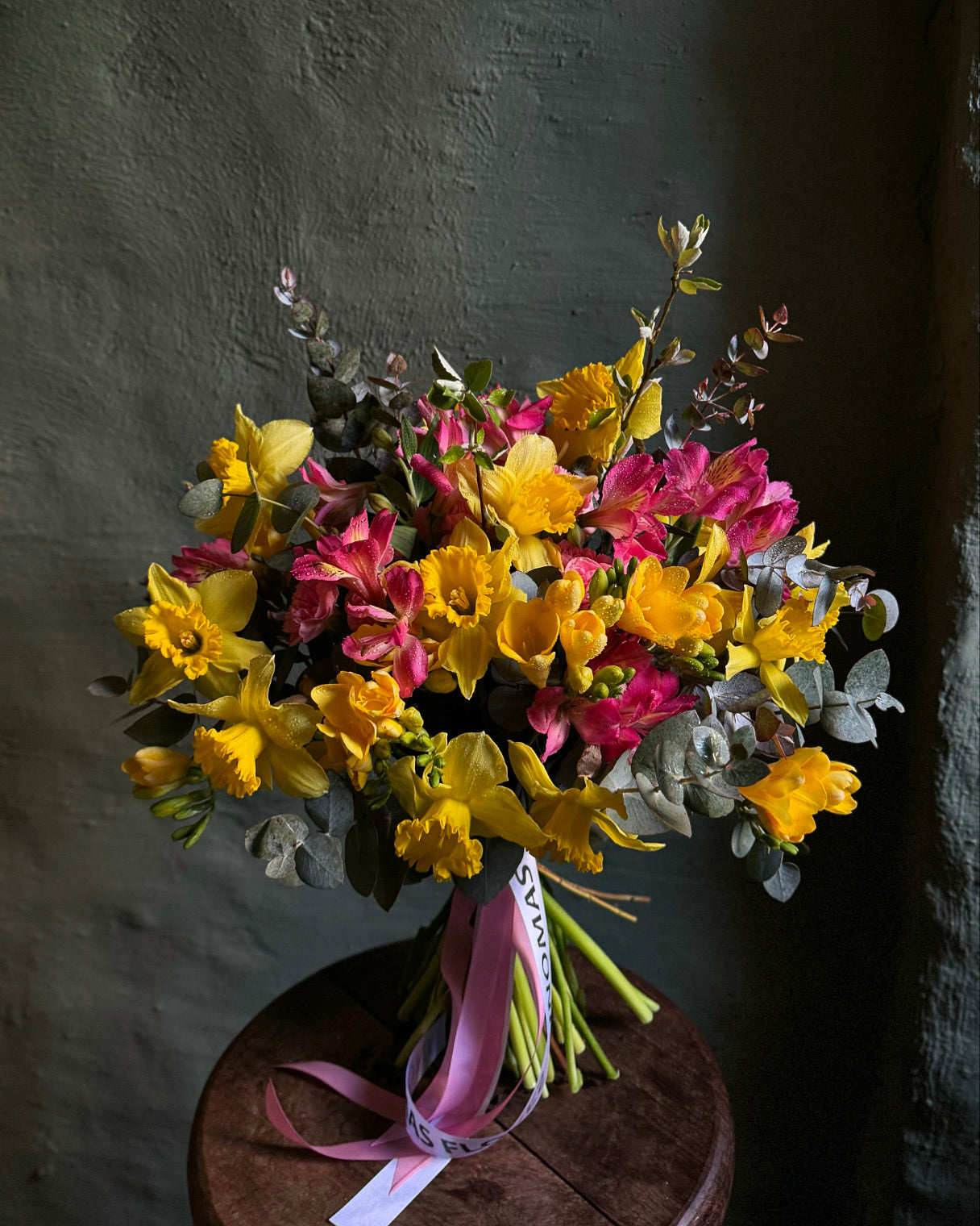 Hand-tied spring bouquet with daffodils and freesias