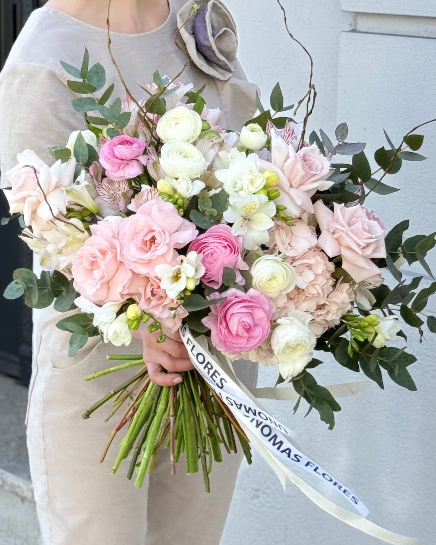 Bouquet of pink and white flowers held by a person