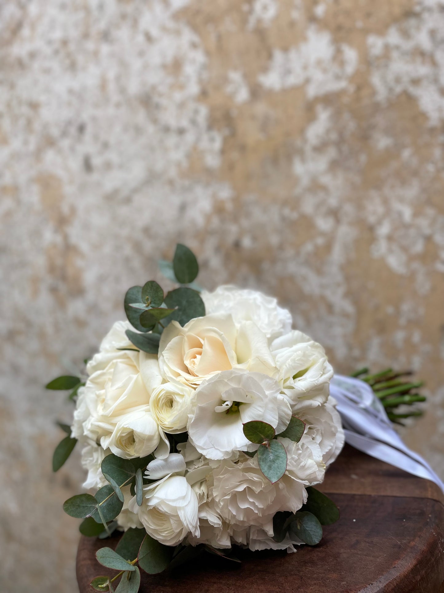 Bridal white bouquet with roses, ranunculus & lisianthus