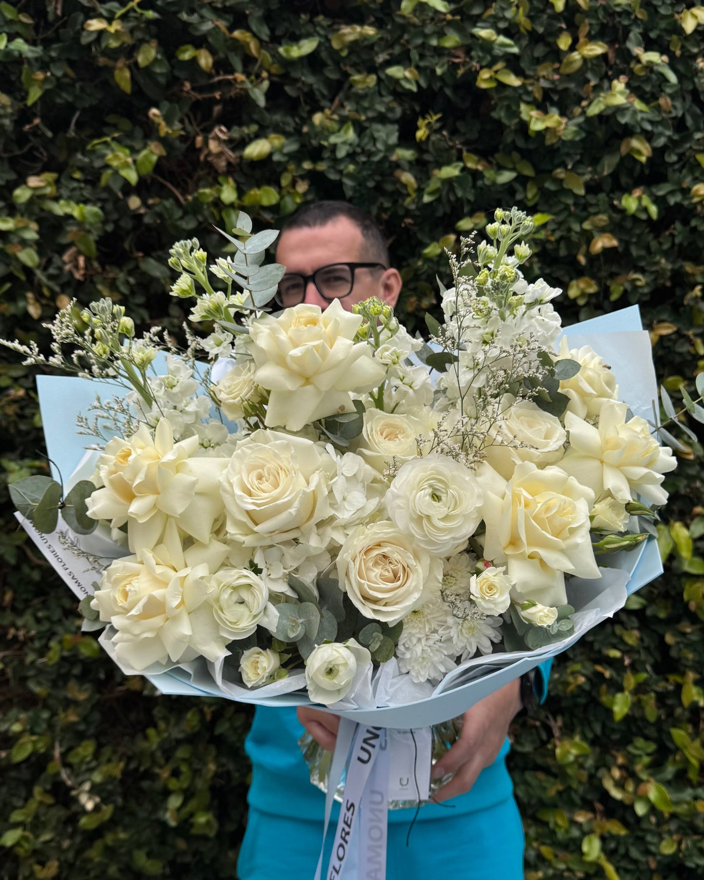 White mixed flower bouquet wrapped in light blue foamiran