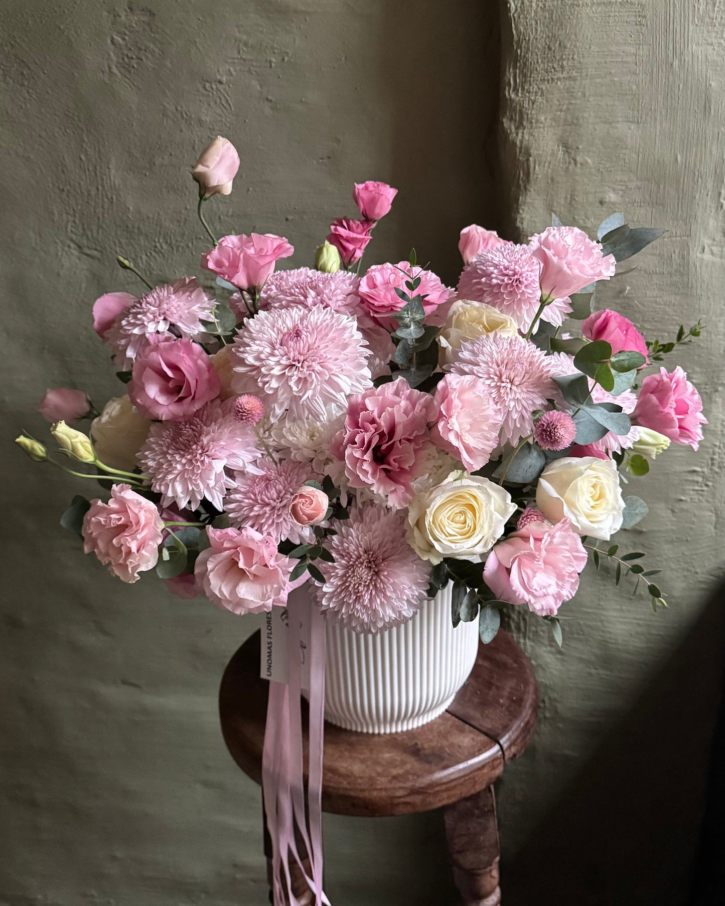 Flower arrangement pink delicate in a cachepot