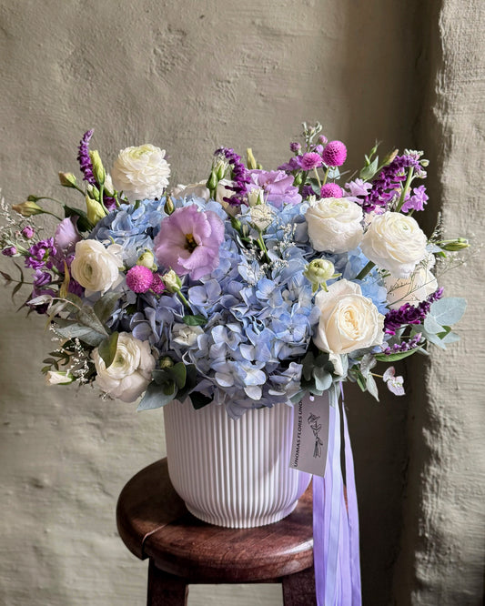 Floral arrangement gentle light blue with hortensias