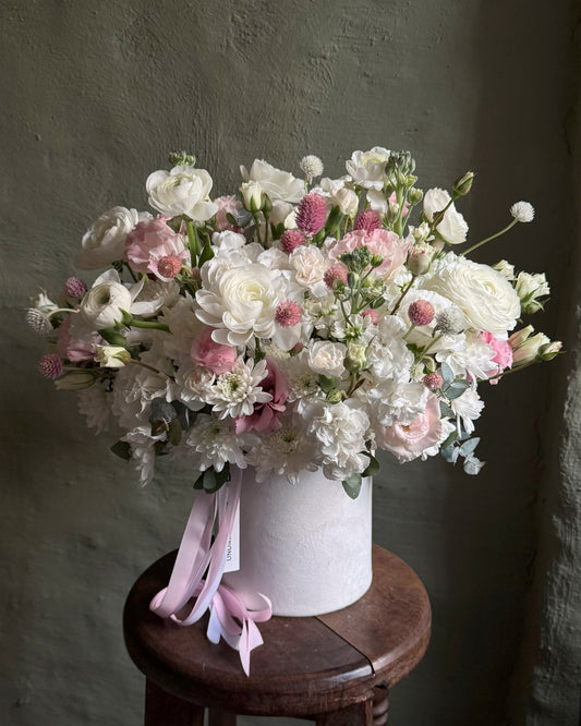 Flower arrangement white & pink seasonal in a hat box
