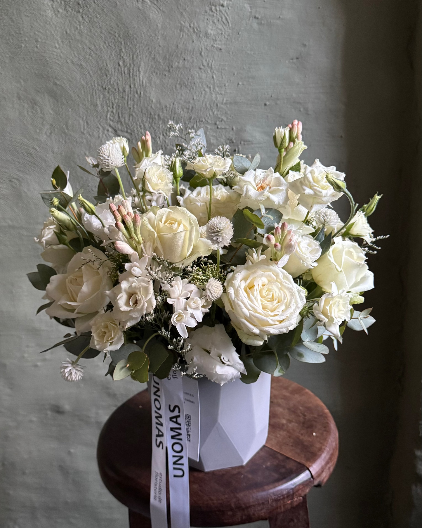Bouquet of white flowers in a geometric cachepot