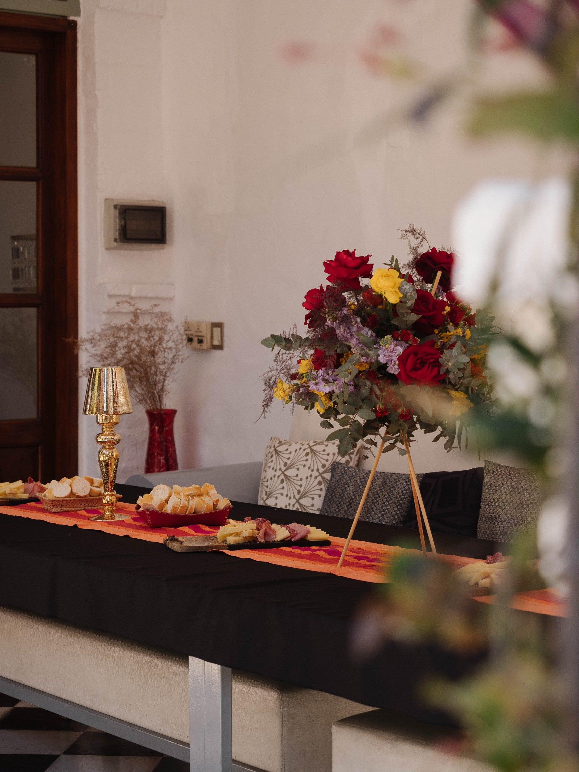 Decorative table setting with flowers and food in a room