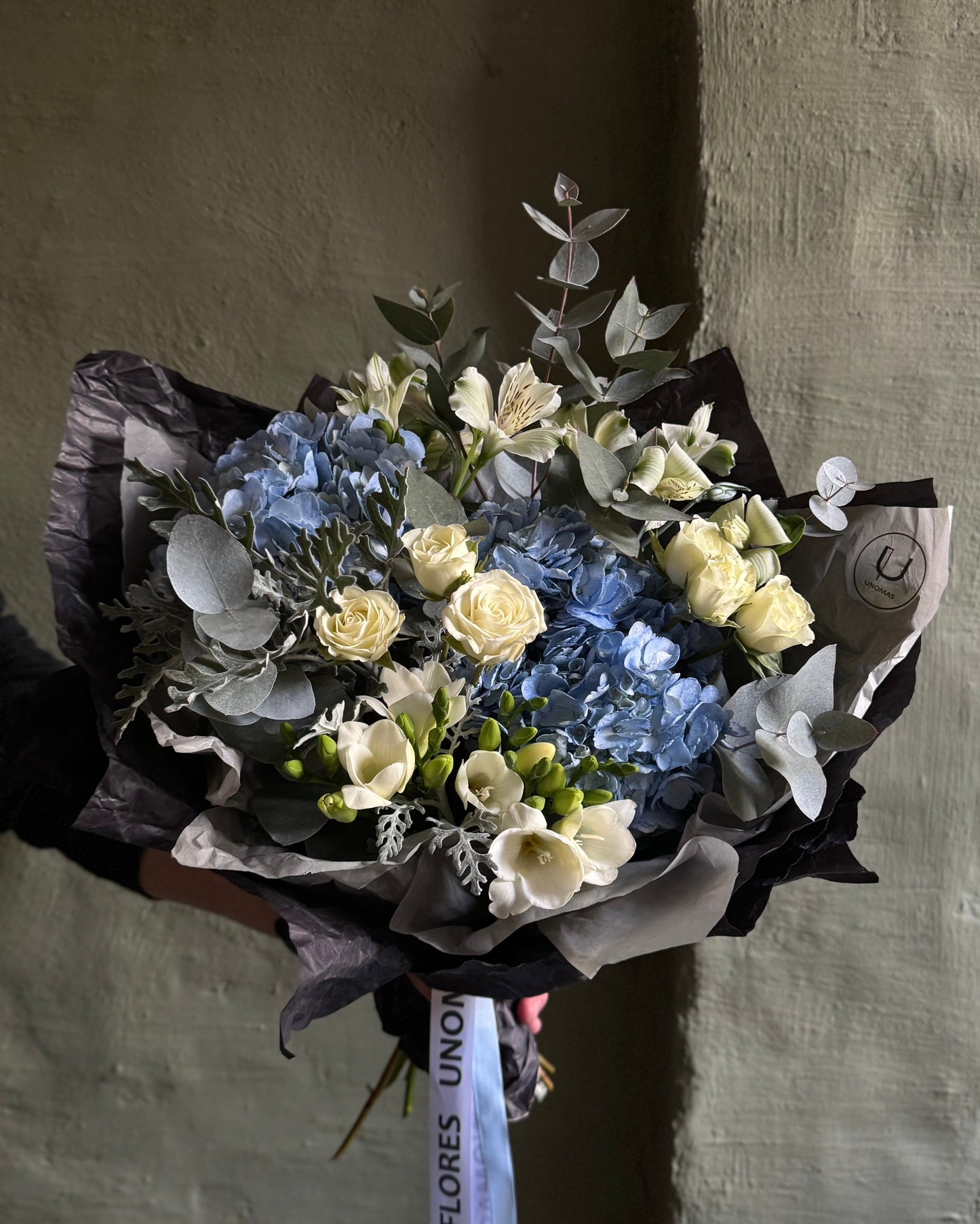 Mixed flower bouquet in dark gift paper