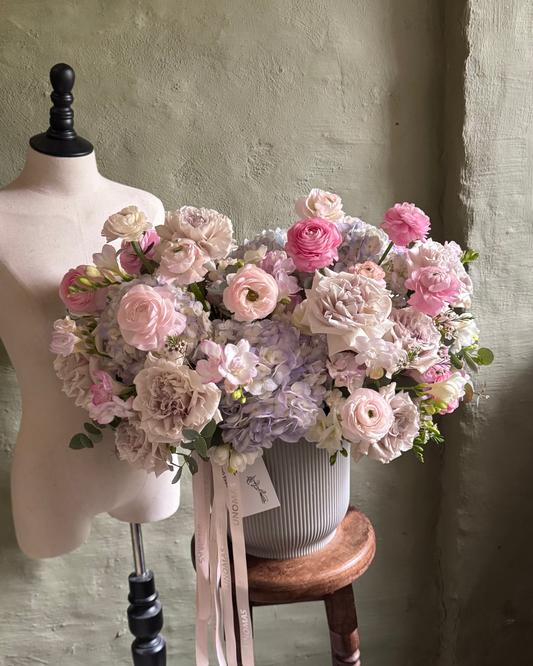 Floral arrangement gentle pink & violet with hydrangeas in a cachepot