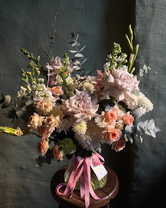 Pastel mixed flower hand-tied bouquet with Ecuadorian and spray roses