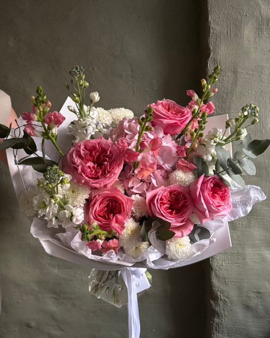 Bouquet of pink and white flowers, roses, matthiola on a dark background