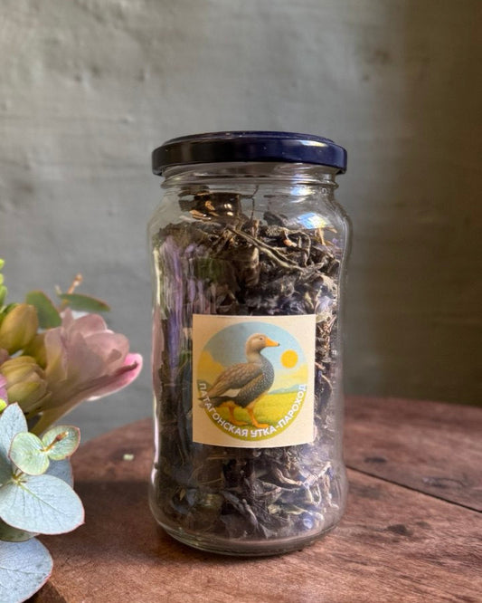 Glass jar with a label on a wooden surface with a blurred background